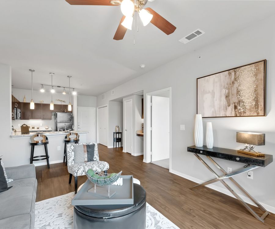 Gateway Cedars apartment designer kitchen, wood plan flooring, and modern furnishings