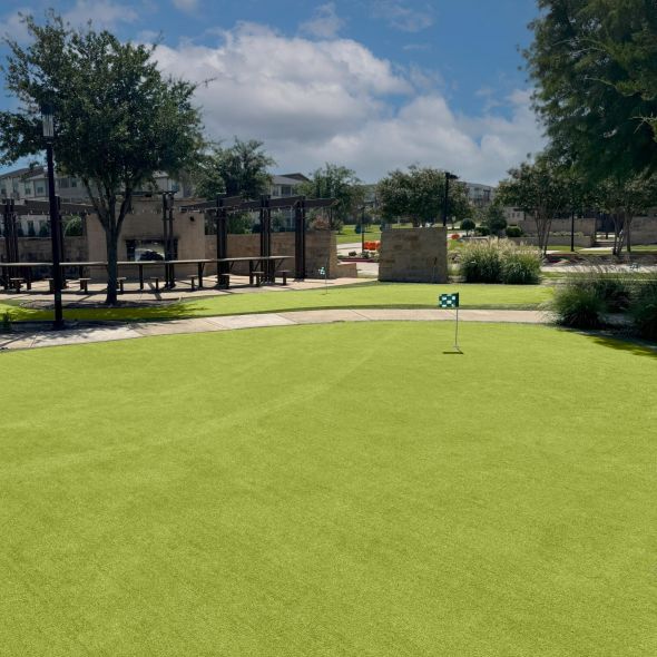 Gateway Cedars apartment exterior with a groomed green lawn and golf course.